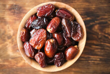 Dried Dates In Wooden Cup. Fruits And Healthy Food.