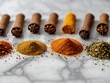 Bright aromatic set of spices on white marble table top view - culinary aromatic spice set with a variety of bright and aromatic ingredients. Colorful spice arrangement on marble
