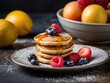 Delicious and homemade mini pancakes as a sweet perfect snack Poffertjes with fruits as sweet breakfast. Sweet breakfast delight: Poffertjes with fruits