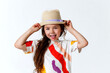 Funny little girl makes faces and shows her tongue on white studio background.