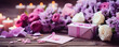 A wooden table hosts a romantic tableau of purple and pink flowers, flickering candles, and an elegant gift box, setting a scene of love, celebration, and intimate ambiance.