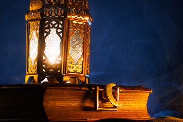 Ornamental Arabic lantern with burning candle glowing at night.Festive greeting card, invitation for Muslim holy month Ramadan Kareem.