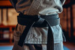 A man practicing martial arts in a dojo, with a black belt around his waist --ar 3:2 --v 6 Job ID: a2ebad94-1088-4ffe-82e1-6323cd4e3d66