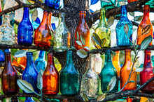 Colorful Glass Bottles Lined Up On Tree Branches, DIY Outdoor Decor
