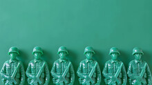 A Row Of Green Plastic Toy Soldiers Is Neatly Arranged In Profile, Each Molded In A Standing Pose With Varying Military Equipment, Showcased Against A Monochromatic Teal Backdrop. 