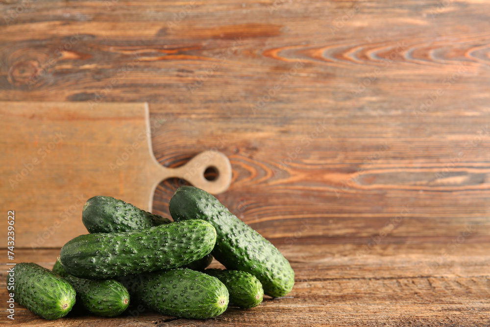 Heap of fresh cucumbers on wooden background