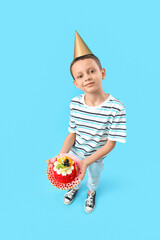 Poster - Cute little boy with Birthday cake on blue background