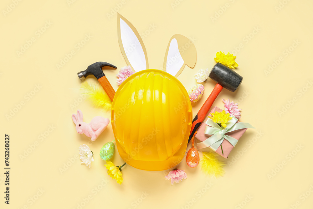 Composition with constructor's tools, gift box and Easter decor on color background