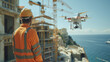 Two Specialists Use Drone on Construction Site. Architectural Engineer and Safety Engineering Inspector Fly Drone on Building Construction Site Controlling Quality near ocean