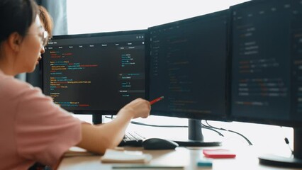Slow motion back end software developer engineer for computer programming working together on debugging writing computing code, solving complex algorithms display on monitor in office. Burgeoning
