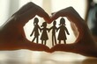 Family unity concept with hands forming a heart around paper cutouts of a family Symbolizing love Support And community care on significant awareness days.