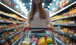 Female customer shopping at supermarket with trolley