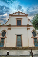 Wall Mural - Piana village in Corsica, the church, in a typical street
