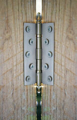 Wall Mural - new, modern door hinge screwed to old wooden door. hinges on a wooden door. Close-up. window door hinge hinge wooden window hinge