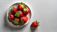 Strawberries On A White Plate , On A White Background