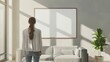 © Pro Hi-Res - Rear view of a woman standing in living room and looking at blank framed poster on the wall. Concept of home decoration.