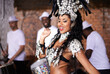 Dancer, carnival and woman with band, happy and pride for culture with group for music performance in night. Girl, men and people dancing at event, party or celebration for history in Rio de Janeiro