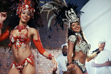 Wall Mural - Portrait, carnival or women in costume dancing for celebration, music culture or samba in Brazil. Girl friends, night or dancers with rhythm or fashion at festival, parade or show in Rio de Janeiro