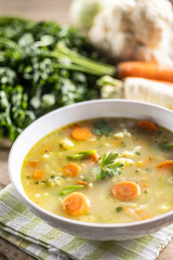 Wall Mural - Spring vegetable soup with chopped and grated root vegetables, seasoned with yeast. Healthy vegetable vegetarian food