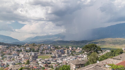 Wall Mural - Panorama showing Gjirokastra city from the viewpoint with many typical historic houses of Gjirokaster timelapse.