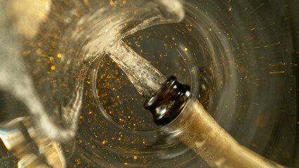 Wall Mural - Freeze Motion Shot of Champagne Wine Pouring, Unique Angle of View from the Bottom of the Glass