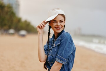 Wall Mural - Happy Summer Fashion: Pretty Caucasian Woman with Stylish Hat and Smiling Face Enjoying Outdoor Vacation in a Green Park with Sunny Nature Background