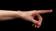 © NooPaew - Female hand, thumb-side view, forefinger pointing away. Hand gestures - woman indicating on virtual object with index finger, isolated on black background, copy space.