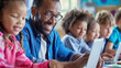 © Lila Patel - Diverse male teacher using laptop teaching children in elementary school class