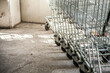 © Austockphoto - Close up of side and wheels of shopping trolleys in a line