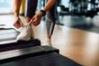 © Drazen - Close up of athletic woman tying shoelace while exercising in health club.