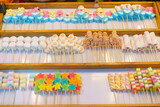 Fototapeta Paryż - Colorful Candy Skewers at a Market Stall