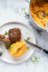 Wall Mural - Mashed potatoes with sweet potatoes on a plate with meatballs. Homemade cooked meal
