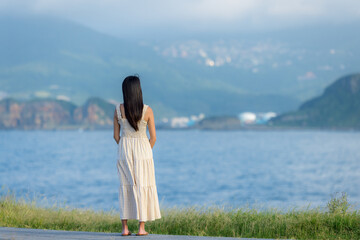 Sticker - Asian woman wear dress and look at the sea