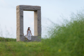 Wall Mural - Woman sit on the rock stone and look around the view