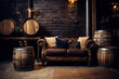A leather couch and wine barrels in a dark cellar with brick walls and dim lighting.