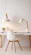Minimalist home office interior with white walls, wooden desk and chair, and stylish lamp.