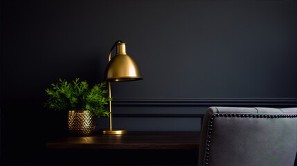 Wall Mural - A golden lamp and a green plant on a wooden table with a gray chair in the background against a dark gray wall.