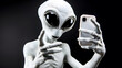 An alien holding a smartphone, engaging in the human-like activity of taking a selfie.

