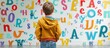 © vxnaghiyev - Child with dyslexia is standing in front of a whiteboard with many letters in elementary school. with copy space image. Place for adding text or design