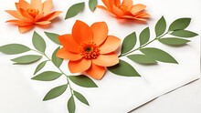 Glossy Orange Flowers, Close-up Of A Paper Flower With Leaves On A White Background Of A Postcard With A Place For Text. For Decorating Spring Or Wedding Themes, Greeting Cards, Scrapbooking And Craft