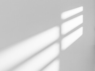 Wall Mural - Gray window shadow and light blur abstract background on white wall.