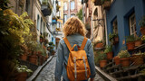 Fototapeta Fototapeta uliczki - woman with backpack is walking down the narrow streets