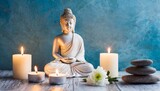 Fototapeta Desenie - calming spa setting buddha and burning small white candles against blue textured wall wellbeing time concept place for text