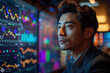 © sofiko14 - Asian man trader in suit on the background of huge monitors with charts.