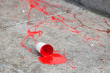 Fototapeta  - Kubek farby. Czerwona plama na chodniku. Krwawa plama.