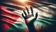 A silhouette of a hand reaching upwards in front of the fluttering Palestinian flag, capturing a sense of hope, determination, and patriotic spirit. AI Generated
