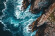 This photo captures an aerial view of the ocean, showcasing the powerful waves crashing against a rocky shoreline, Overhead capture of a rugged coastline caressed by a soothing sea, AI Generated