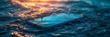 Stranded smartphone lies amidst the sparkling waves at golden hour, evoking themes of loss and technology