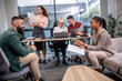 © Mediteraneo - Office colleagues having discussion during meeting in conference room. Group of men and women in modern office.