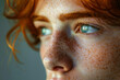 A person with freckles in a close-up portrait, focusing on natural beauty.